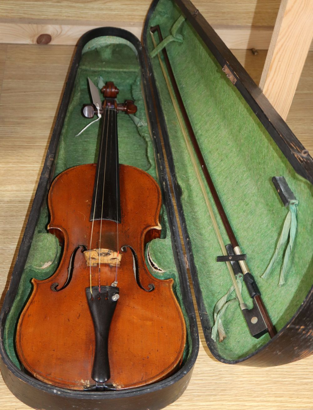 A late 19th century European violin with inlaid decoration, cased with bow, Joseph Guanaris label to interior of violin